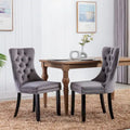 Set da 2 sedie da pranzo contemporanee di lusso con schienale capitonné, struttura in legno massello, rivestimento in velluto e gambe in legno con borchie decorative, colore Oro